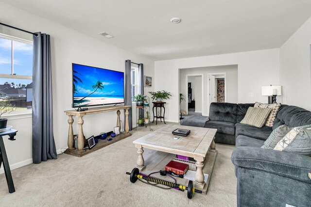 living room with carpet flooring and a healthy amount of sunlight