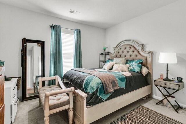 bedroom with light colored carpet