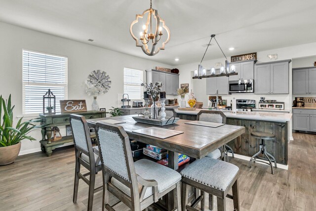 dining area featuring hardwood / wood-style flooring and a notable chandelier