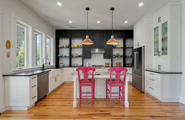 409 W Indian Ave, Folly Beach, SC 29439 - kitchen featuring a center island, open shelves, a sink, recessed lighting, and stainless steel appliances