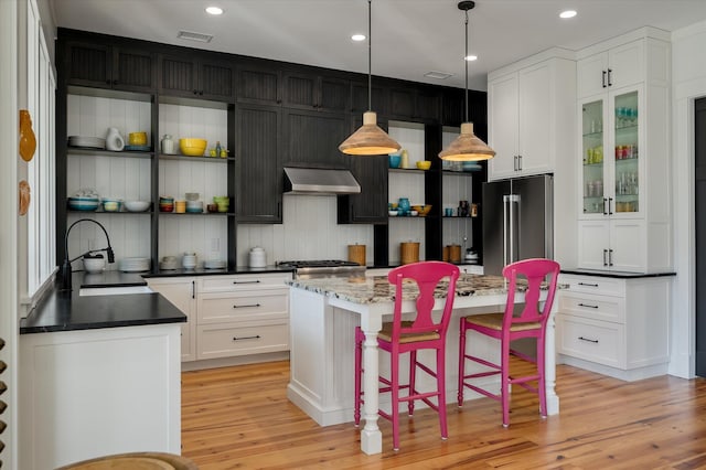 409 W Indian Ave, Folly Beach, SC 29439 - kitchen featuring exhaust hood, open shelves, white cabinets, high end refrigerator, and a sink