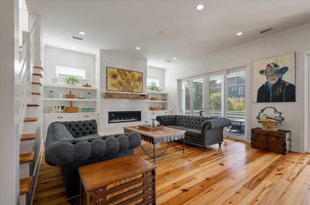 409 W Indian Ave, Folly Beach, SC 29439 - living room with recessed lighting, a fireplace, visible vents, and light wood-type flooring