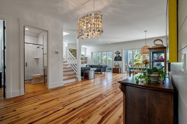 409 W Indian Ave, Folly Beach, SC 29439 - interior space featuring a chandelier, light wood-type flooring, and stairway