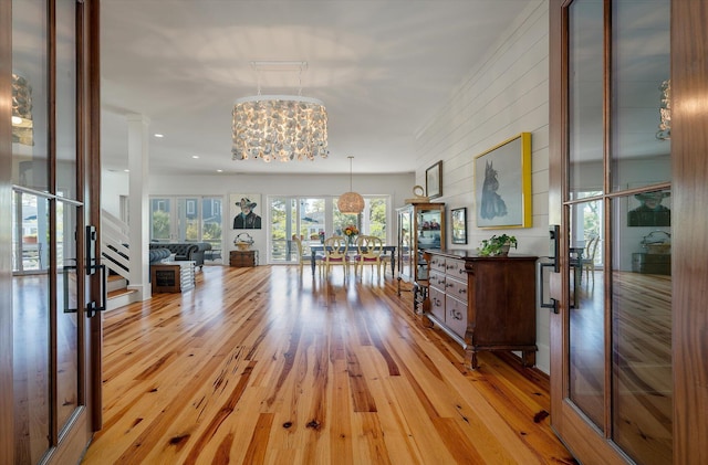409 W Indian Ave, Folly Beach, SC 29439 - hall featuring stairs, a notable chandelier, and light wood-type flooring