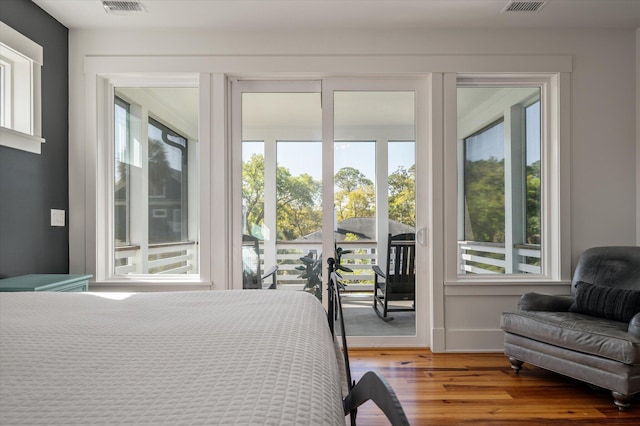 409 W Indian Ave, Folly Beach, SC 29439 - bedroom featuring light wood-type flooring, visible vents, and access to exterior