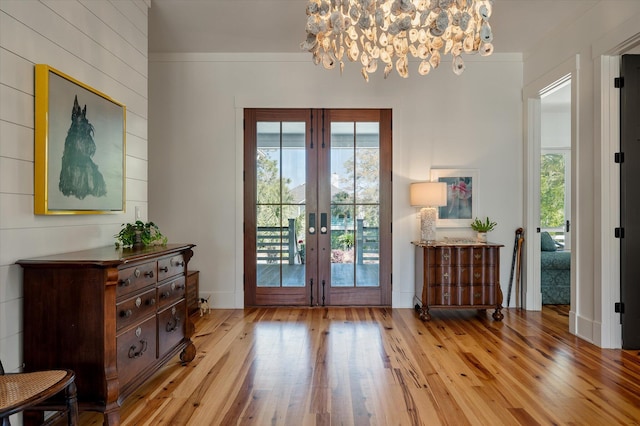 409 W Indian Ave, Folly Beach, SC 29439 - doorway with an inviting chandelier, plenty of natural light, french doors, and hardwood / wood-style floors