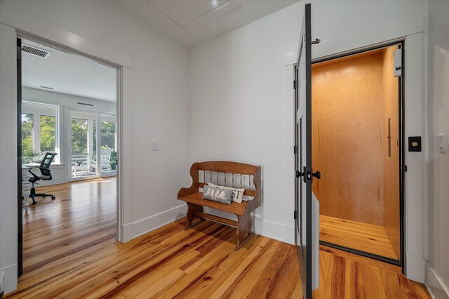 409 W Indian Ave, Folly Beach, SC 29439 - interior space featuring light wood-style flooring, baseboards, visible vents, and elevator