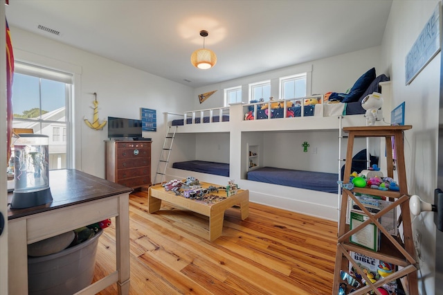 409 W Indian Ave, Folly Beach, SC 29439 - bedroom featuring visible vents and wood finished floors