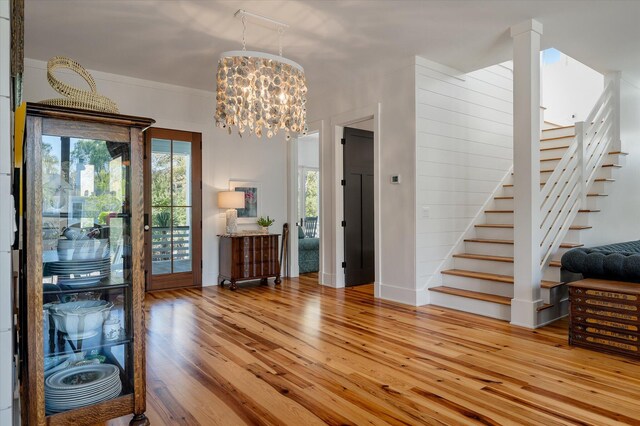 409 W Indian Ave, Folly Beach, SC 29439 - foyer with a notable chandelier, hardwood / wood-style floors, baseboards, and stairs