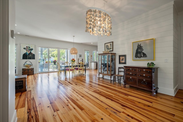 409 W Indian Ave, Folly Beach, SC 29439 - dining space featuring wood walls, recessed lighting, hardwood / wood-style flooring, and an inviting chandelier