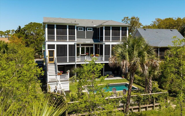 409 W Indian Ave, Folly Beach, SC 29439 - rear view of property with stairs, a patio, a sunroom, and an outdoor pool