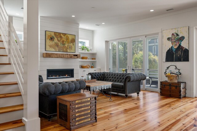 409 W Indian Ave, Folly Beach, SC 29439 - living area with a fireplace, visible vents, recessed lighting, stairway, and wood-type flooring