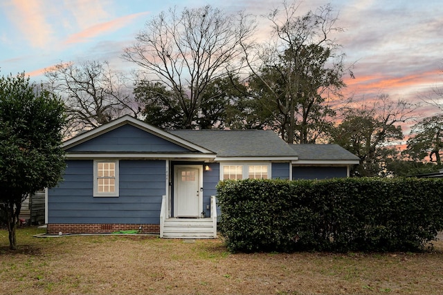 view of front facade with a garage, a front yard, and entry steps