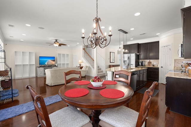 dining room with ornamental molding, dark hardwood / wood-style flooring, and ceiling fan with notable chandelier