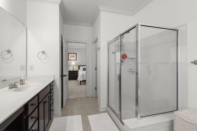 bathroom featuring vanity, crown molding, a shower with shower door, and tile patterned floors