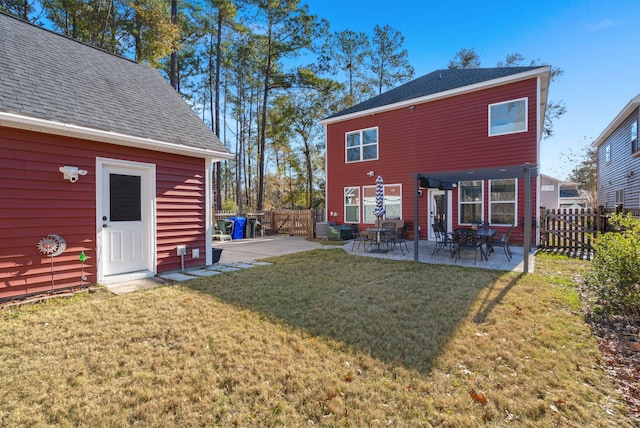 rear view of house with a yard and a patio area