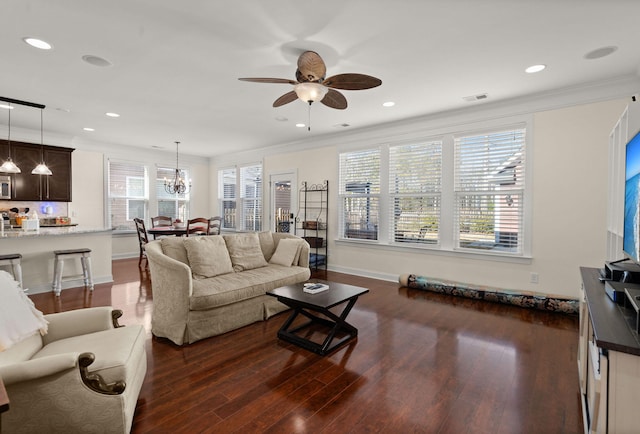 living room featuring crown molding and a wealth of natural light