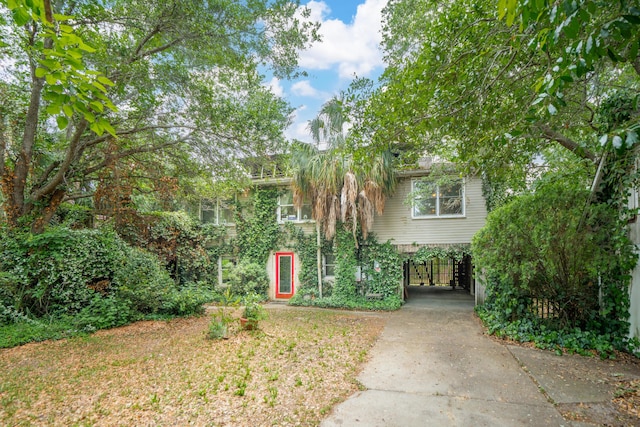 3109 Ion Ave, Sullivans Island, SC 29482 - view of property hidden behind natural elements with a carport and concrete driveway