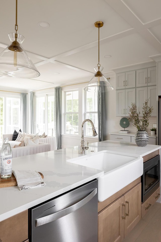 kitchen featuring stainless steel dishwasher, built in microwave, a wealth of natural light, and a sink