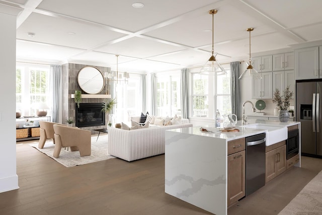 kitchen featuring appliances with stainless steel finishes, coffered ceiling, and a sink