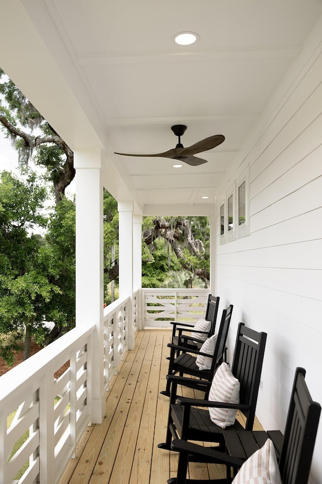 deck with a ceiling fan and covered porch