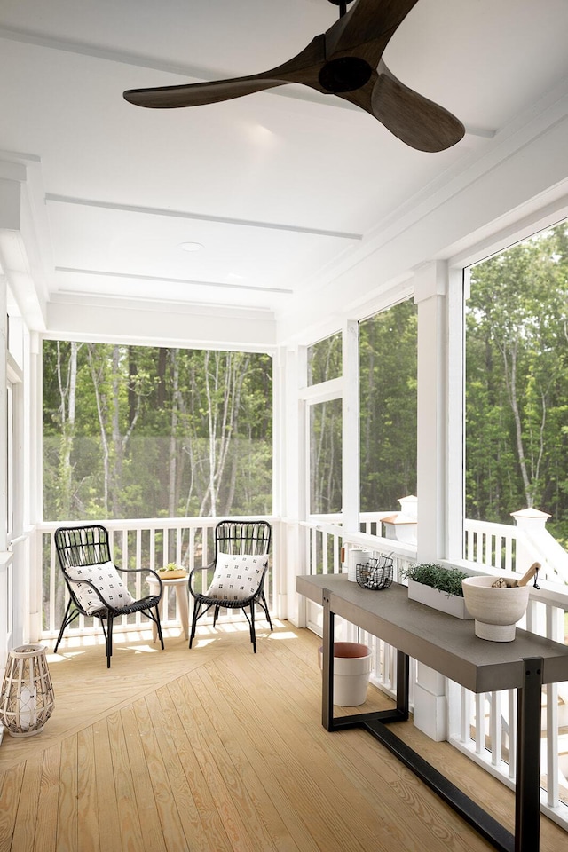 unfurnished sunroom with ceiling fan