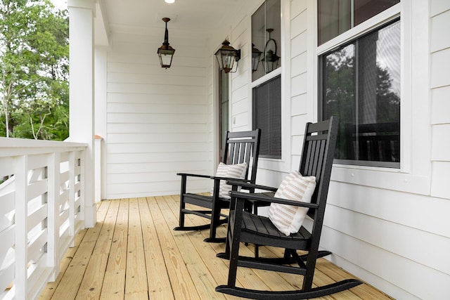 wooden terrace featuring covered porch