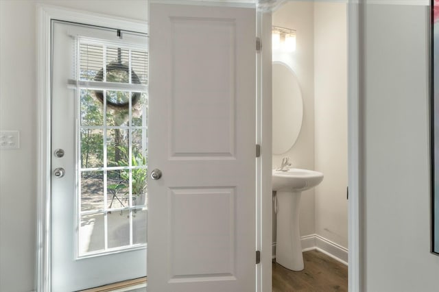 doorway featuring sink and hardwood / wood-style floors