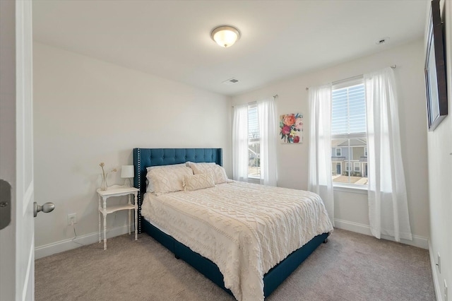 bedroom featuring light carpet