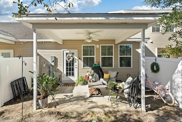 rear view of house featuring ceiling fan and a patio area