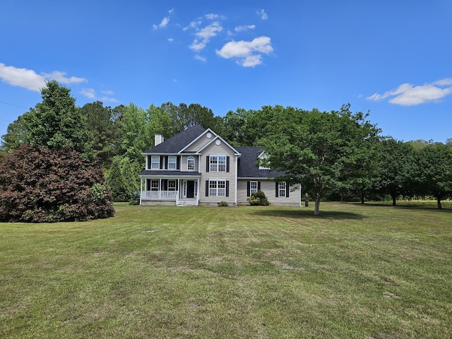 3564 Elliott Rd, Pinewood, SC 29125 - view of front facade with a porch, a front yard, and a chimney