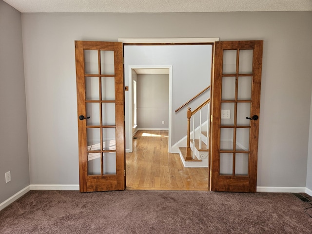 3564 Elliott Rd, Pinewood, SC 29125 - carpeted empty room with french doors, stairway, and baseboards