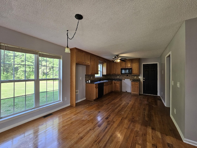 3564 Elliott Rd, Pinewood, SC 29125 - kitchen with black appliances, dark wood-style floors, a textured ceiling, and baseboards