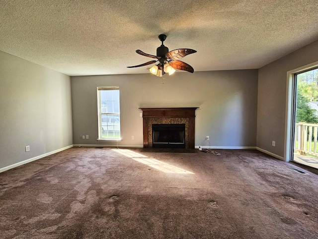 3564 Elliott Rd, Pinewood, SC 29125 - unfurnished living room featuring a fireplace, a ceiling fan, carpet, baseboards, and a textured ceiling
