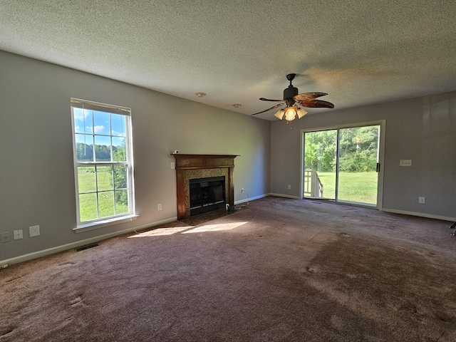 3564 Elliott Rd, Pinewood, SC 29125 - unfurnished living room featuring a fireplace, a ceiling fan, carpet flooring, baseboards, and a textured ceiling