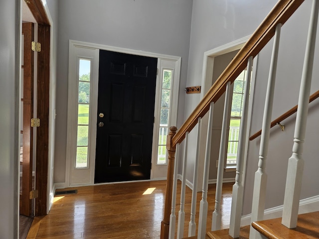3564 Elliott Rd, Pinewood, SC 29125 - foyer entrance featuring stairs, wood finished floors, healthy amount of natural light, baseboards, and a high ceiling