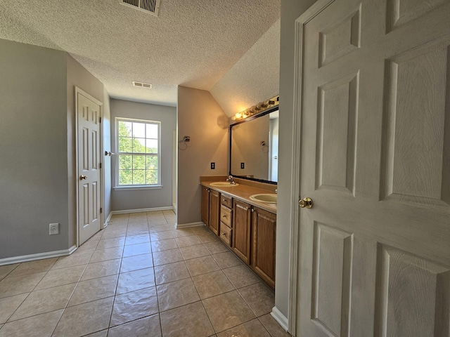3564 Elliott Rd, Pinewood, SC 29125 - bathroom featuring baseboards, double vanity, and a textured ceiling