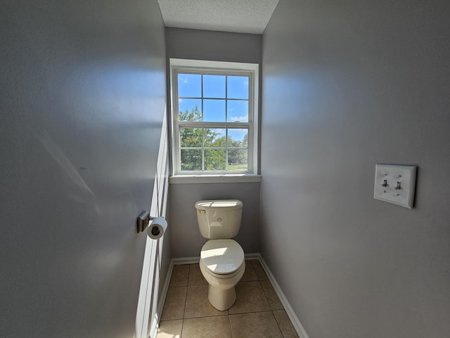 3564 Elliott Rd, Pinewood, SC 29125 - bathroom with tile patterned floors, baseboards, toilet, and a textured ceiling