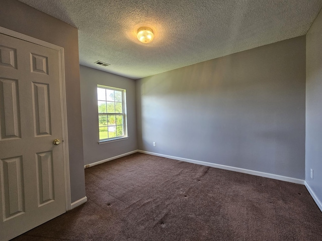 3564 Elliott Rd, Pinewood, SC 29125 - empty room featuring dark colored carpet, baseboards, and a textured ceiling