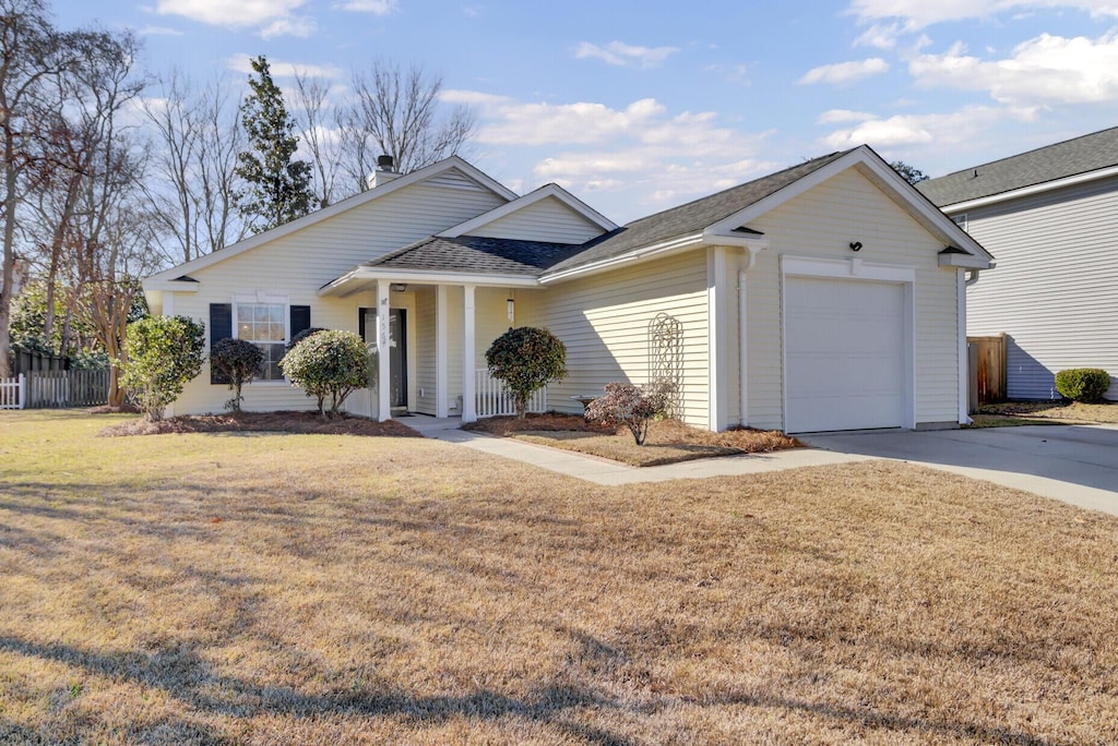 ranch-style home with a garage and a front lawn