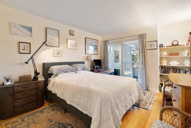 bedroom with access to exterior and light wood-type flooring