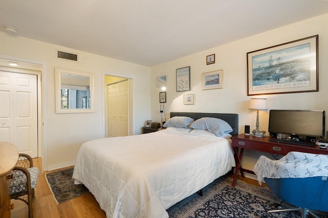 bedroom with wood-type flooring and a closet