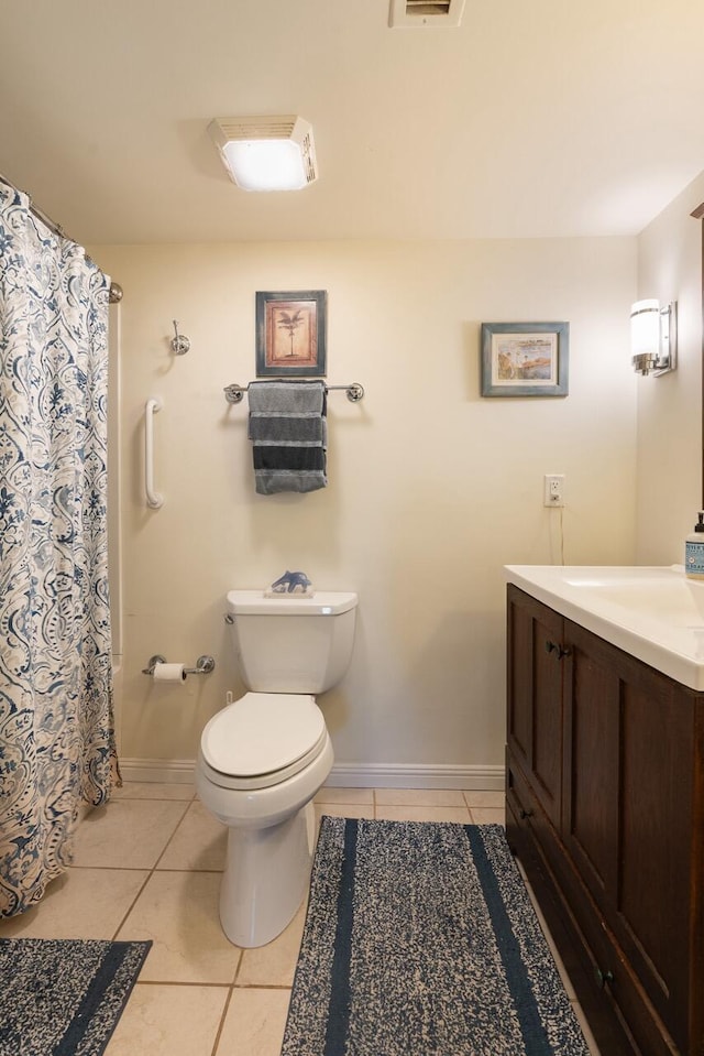 bathroom with vanity, toilet, and tile patterned flooring