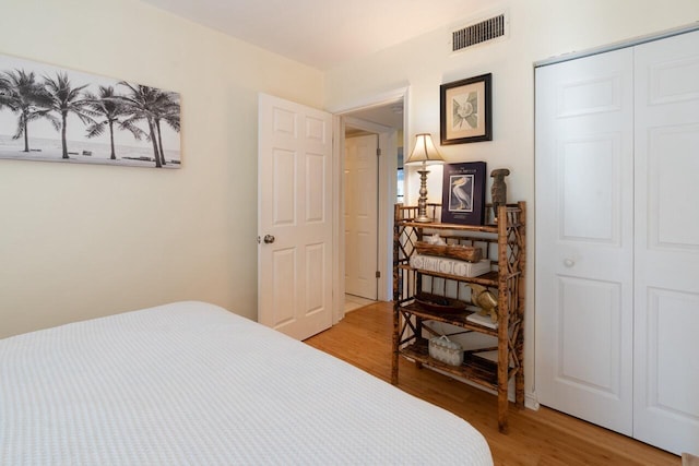 bedroom featuring hardwood / wood-style floors and a closet