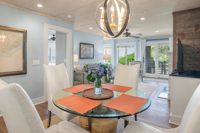 dining space with french doors, crown molding, wood ceiling, ceiling fan with notable chandelier, and hardwood / wood-style flooring