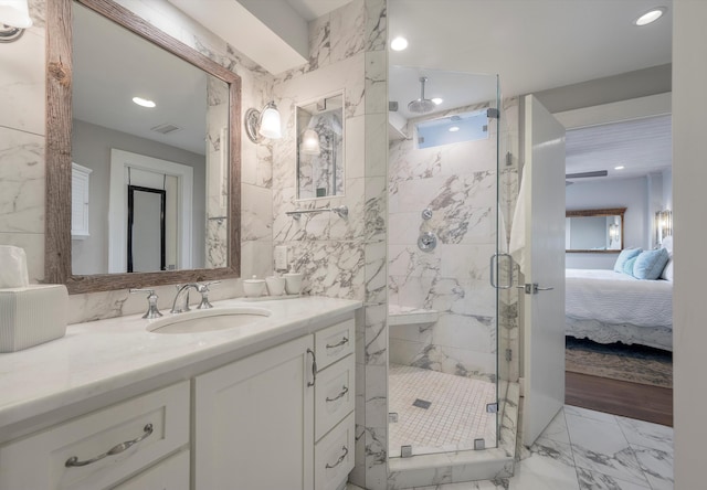 bathroom featuring tile floors, an enclosed shower, and vanity