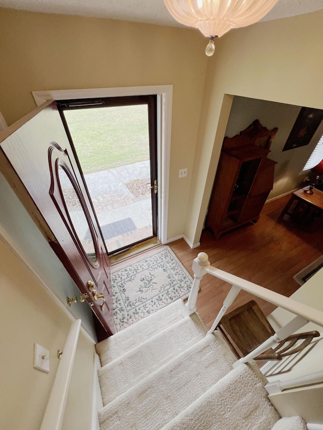 foyer featuring baseboards and light wood-style flooring