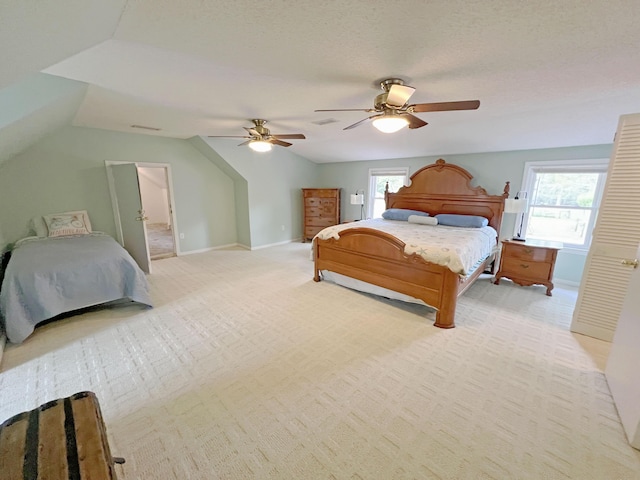 bedroom with visible vents, baseboards, a ceiling fan, lofted ceiling, and light colored carpet