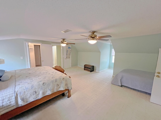 bedroom featuring a textured ceiling, visible vents, carpet, ceiling fan, and lofted ceiling