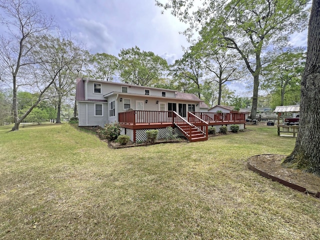 rear view of house featuring a wooden deck and a lawn